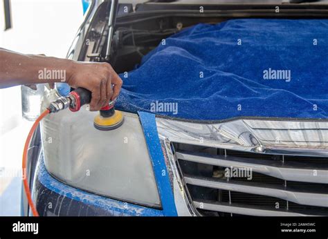 Mechanics Hand Is Polishing The Cars Headlight Stock Photo Alamy