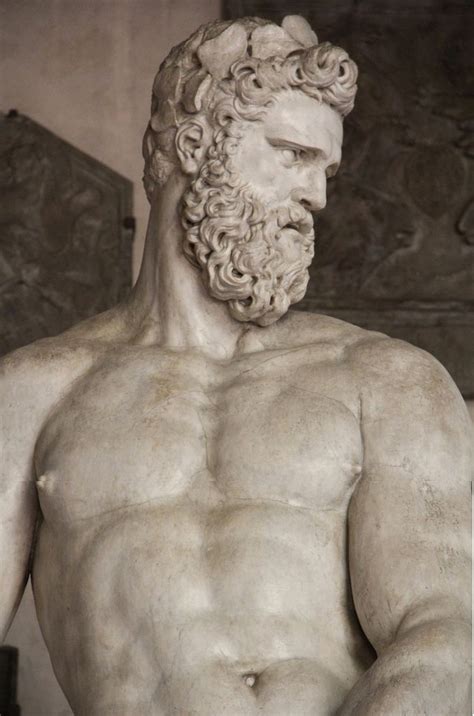 a marble statue of a man with a beard and no shirt holding something in his hand
