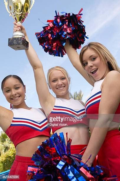 Mixed Race Cheerleader Holding Pom Poms Photos And Premium High Res