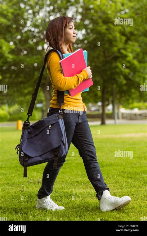 Female College Student With Books Walking In Park Stock Photo Alamy