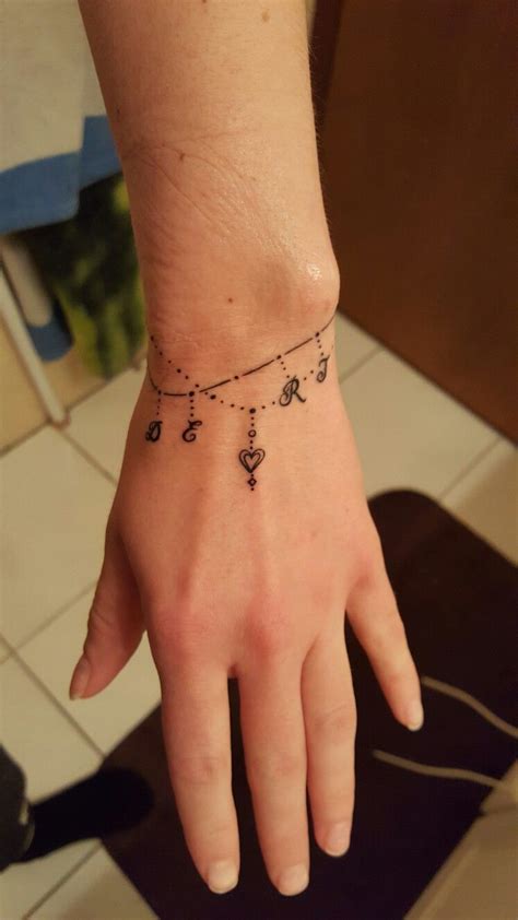 Affordable and search from millions of royalty free images, photos and vectors. Charm bracelet tattoo. | Wrist band tattoo, Wrist bracelet ...
