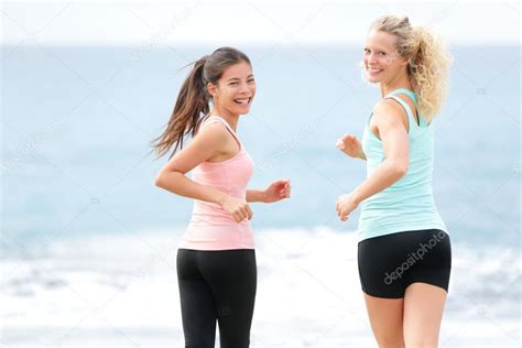 Running Women Jogging Training On Beach — Stock Photo © Maridav 44256325