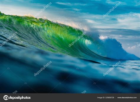 Perfect Barrel Wave In Ocean Breaking Green Wave With Light Stock