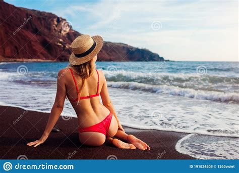 Woman In Bikini Relaxing On Red Beach In Santorini Greece Girl