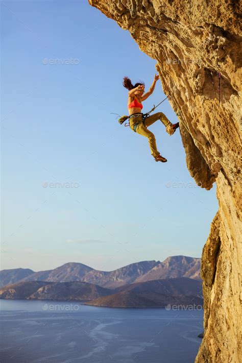 Female Rock Climber Falling Off Cliff While Lead Climbing Stock Photo