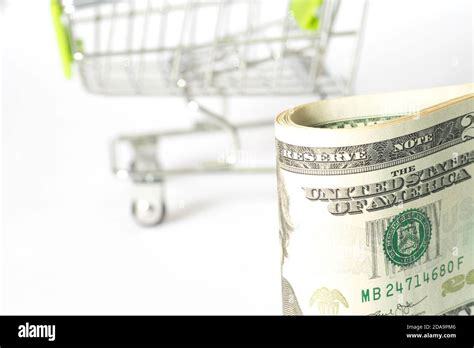 A shopping cart and lots of dollar bills Stock Photo - Alamy