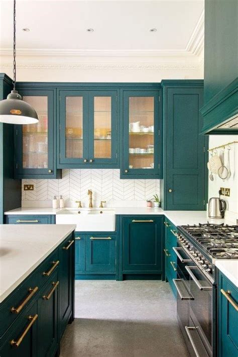 A Teal Kitchen With Glass And Usual Cabinets White Countertops And A