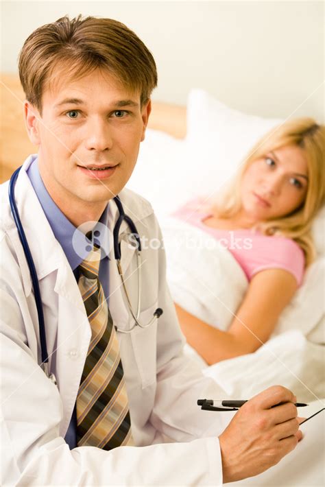 Portrait Of Handsome Doctor Looking At Camera On Background Of His