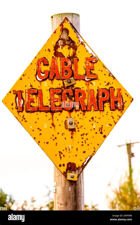 Yellow Diamond Red Writing Sign Cable Rust Power Lines Hi Res Stock