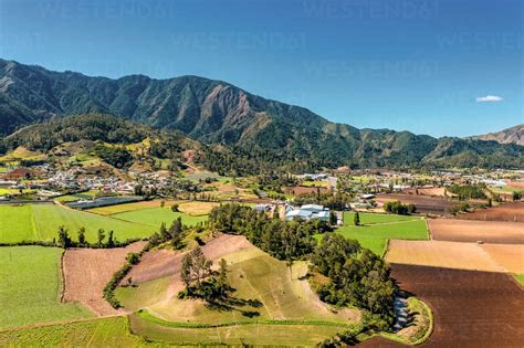 Aerial View Of Large Mountains And Agriculture Under A Clear Sky In The