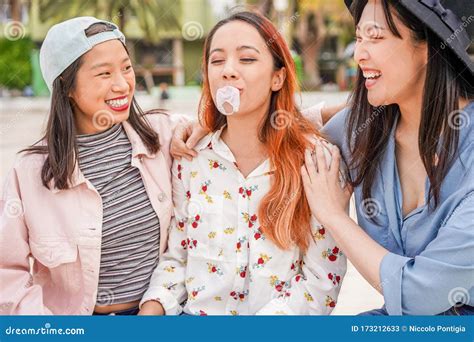 Trendy Asian Girls Having Fun Together Outdoor Young Women Friends Playing With Bubble Gum