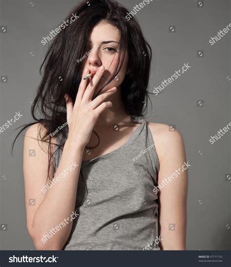 Close Up Portrait Of Young Black Hair Smoking Woman With