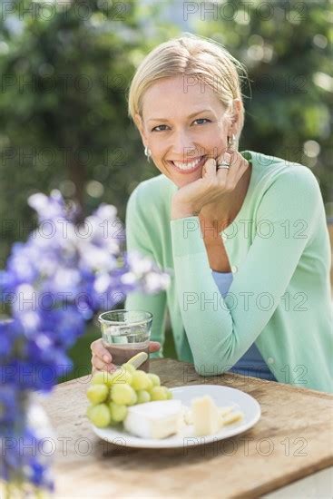 Woman Sitting At Table Outdoors Photo12 Tetra Images
