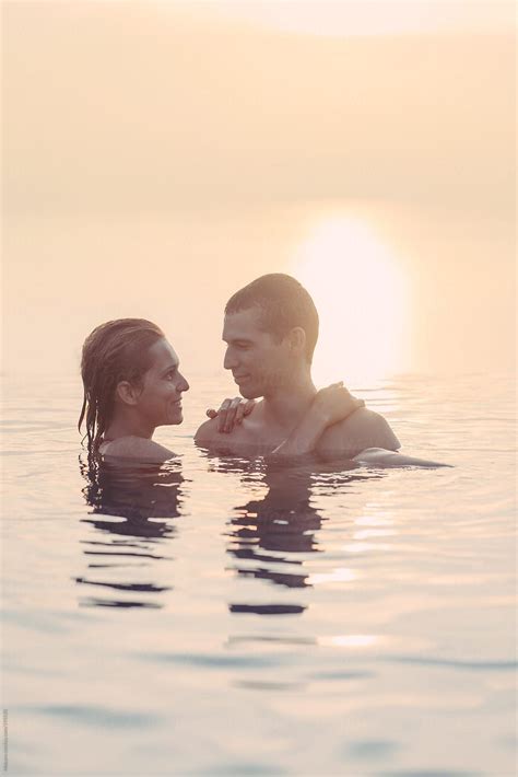 Couple In The Infinity Pool At Sunset By Stocksy Contributor Mosuno