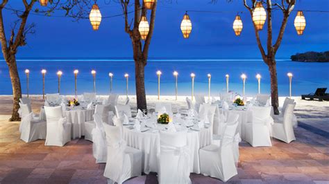 Feel the perfectly soft, white sand caressing your feet as you stroll through the palm trees, listening to the sound of the ocean waves combined with soft romantic music. Wedding Reception Venues | The Laguna Bali