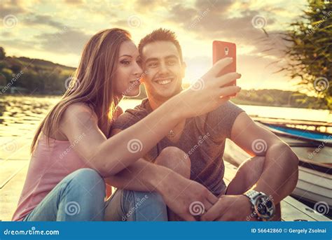 Close Up Selfie Shot Of Smiling Pretty Young Woman In Light Clothes