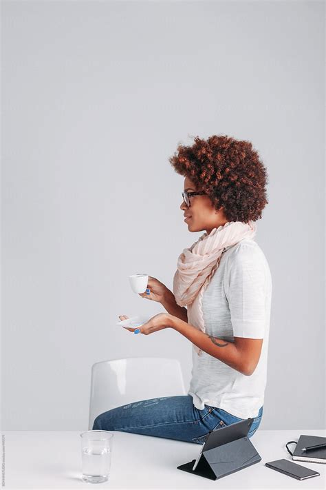 Side Profile Of Casual Afro Businesswoman Taking A Coffee In A Office