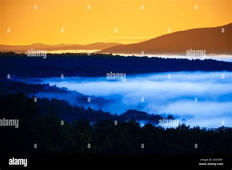 Early Morning Sunrise Of A Fog Enshrouded Valley In The New England