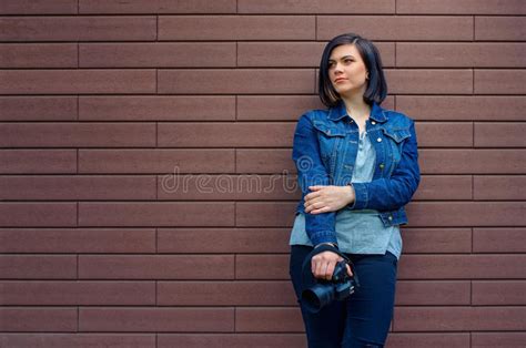 thoughtful girl in a blue jeans jacket with digital camera stock image image of female camera