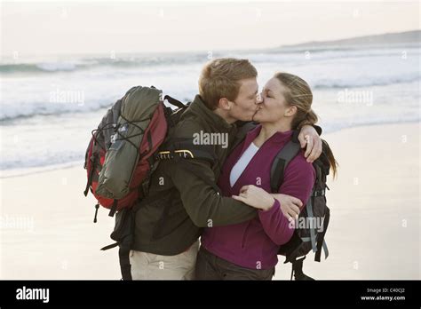 Backpacking Couple Kissing At Beach Stock Photo Alamy