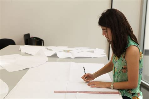 Fashion Design Student In Full Focus While Working On Her Designs