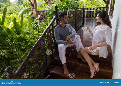 Young Couple On Terrace Tropical Hotel Man And Woman Tropic Holiday Vacation Stock Image