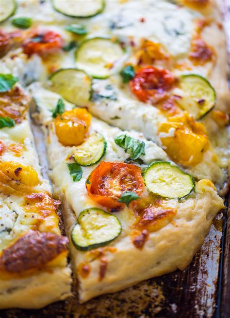 white pizza with tomatoes basil and zucchini baker by nature