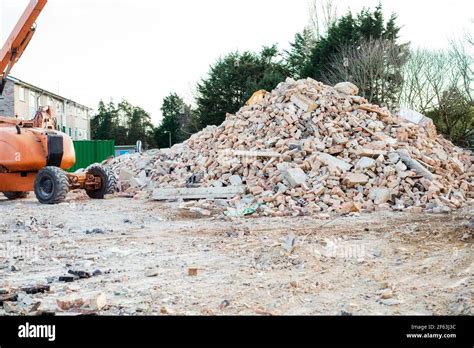 Excavator Removes Construction Waste After Building Demolition