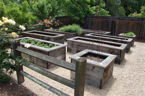 A raised garden bed (or simply raised bed) is a large planting container that sits aboveground and is filled with soil and plants. Napa Valley, Ca - Farmhouse - Landscape - San Francisco - by Back Bay Stone Supply