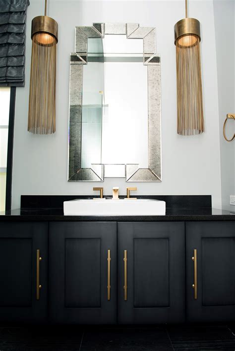 The ideal bathroom lighting helps set. Bathroom Remodel floating vanity, brass fixtures, pendant ...