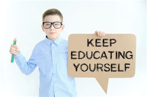 Premium Photo Boy In Glasses Holding A Card With Text Keep Educating