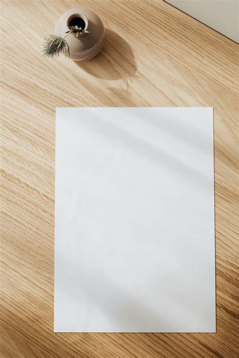 Simply browse an extensive selection. Blank white paper sheet on wooden table · Free Stock Photo