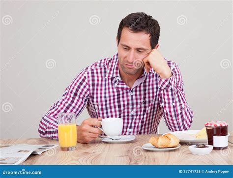 Portrait Of Young Man Having Breakfast Stock Photo Image Of Moody