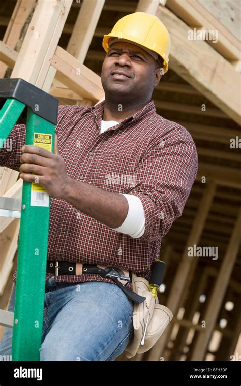 Construction Worker Climbing Ladder Stock Photo Alamy