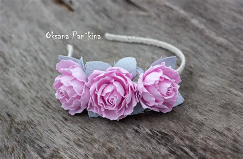 Three Pink Flowers Are On A White Headband