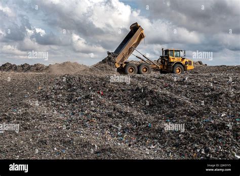 A Dumper Truck On A Large Waste Management Landfill Site Dumping