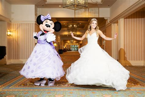 Bride Twirls With Minnie Mouse In A Lavender Dress During A Disney