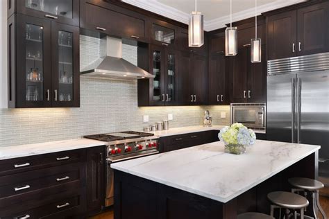 The white upper cabinets combined with the white subway tile keeps things feeling open and airy. Contemporary Kitchen with Glass panel, Pendant Light ...