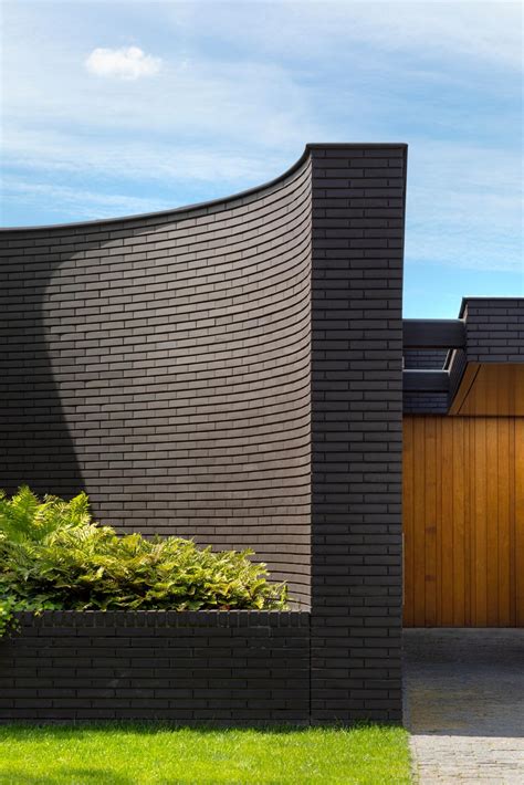 This Home Combines A Black Brick Exterior With Large Glass Walls For A Strong Contemporary Design