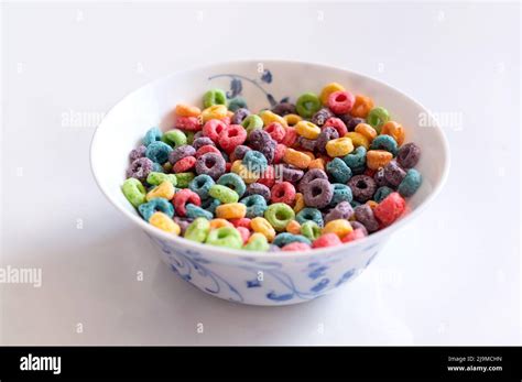Delicious And Nutritious Fruit Cereal Loops With Milk On White