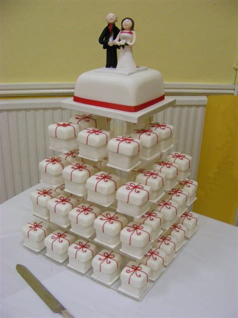A Wedding Cake Made To Look Like It Is Stacked On Top Of Each Other