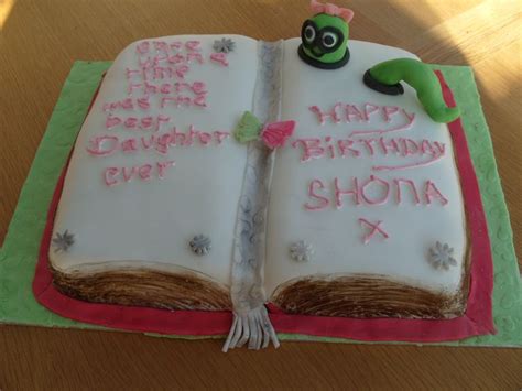 An Open Book Cake With Writing On It
