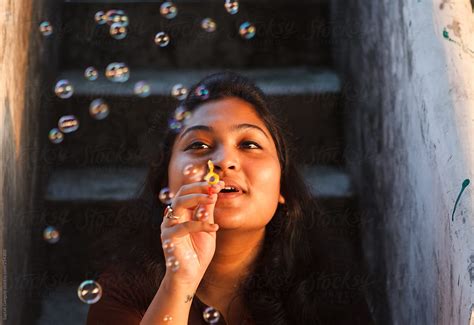 girl blowing bubbles at sunset by stocksy contributor saptak ganguly stocksy