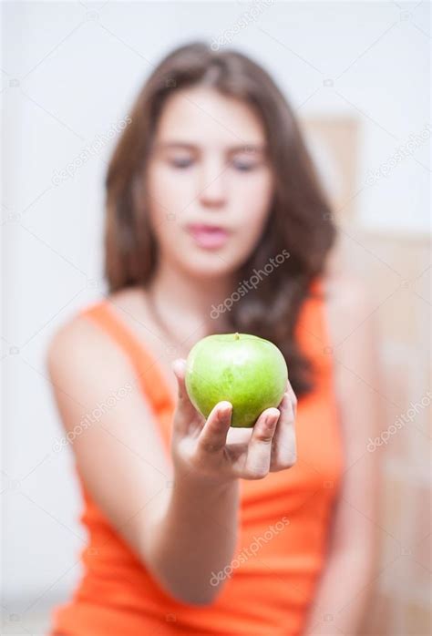 Teen Girl Holding A Beautiful Fresh Green Apple Indoor Selective