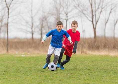 Kids Soccer Football Children Players Match On Soccer Field Stock