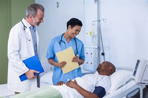 Premium Photo Doctor And Nurse Interacting With Patient During Visit