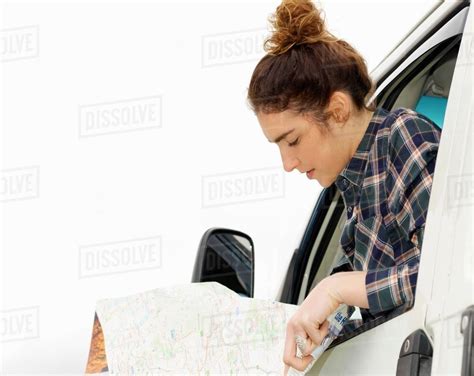 Young Woman Reading Map From Camper Van Window Stock Photo Dissolve