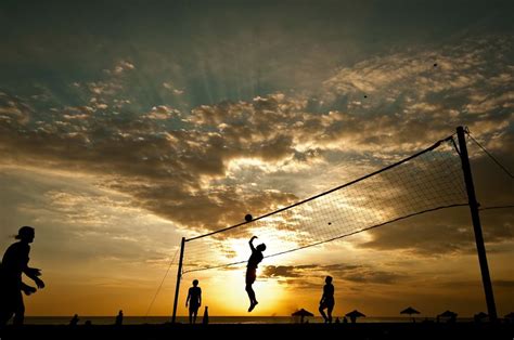 People Playing Volley Ball On The Beach During Sunset Amazing