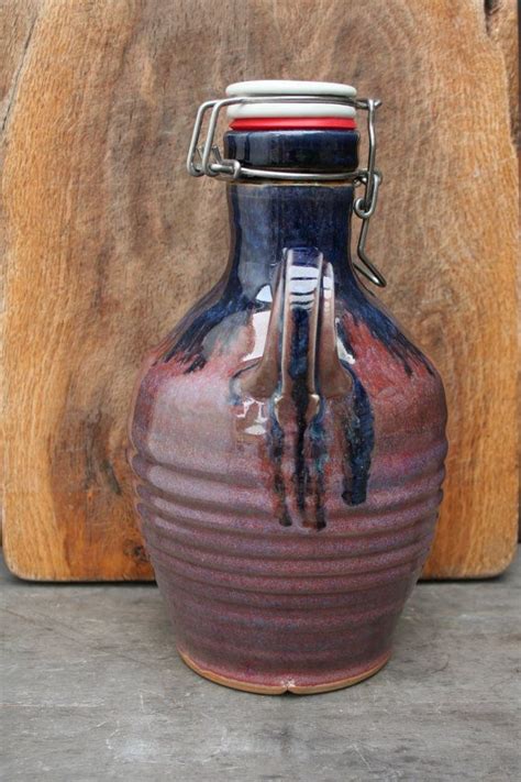 A Blue And Red Vase Sitting On Top Of A Wooden Table Next To A Piece Of