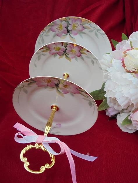 There Are Three Plates With Flowers On Them And One Has A Gold Fork In It